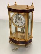 An Edwardian ormolu four glass mantel clock with enamel dial with visible escapement, with arabic