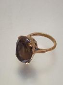 A 9ct gold oval Cairngorm set ring mounted in claw setting (O)