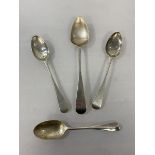 A silver spoon, Newcastle 1819, initial to handle, (17cm) a silver spoon, London 1919, and two white