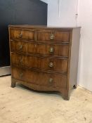 A late 19th century Regency style mahogany bow front chest, with reeded top, two short and three