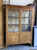 An Edwardian mahogany display cabinet, dentil cornice over two glazed doors enclosing two fixed