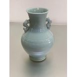 A modern Chinese celadon ware baluster vase with fish scroll handles to side (h.26cm)