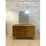 Meredew, A mid century light oak veneered dresseing chest with swing mirror, three drawers and a