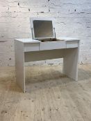 A contemporary white laminate dressing table, the hinged top with mirror and storage well, H111cm,