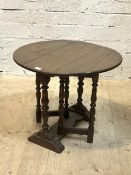 A 19thc gate leg occasional table the oak oval top on turned supports on trestle base H53cm,