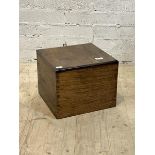 An oak lidded box of dovetail construction with divisions to interior, H35cm, W44cm, D40cm
