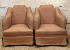 A pair of late 19th century damask upholstered easy chairs with swept arms, raised on turned front