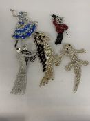 A group of six costume jewellery badges, three marked Butler and Wilson, including teddy bear (10cm)