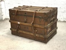 A Large early 20th century metal and wood bound steamer trunk, with leather carry handle to each