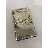 A silver card case, Birmingham 1903, with initials to front and scrolls to edges, (9cm x 5cm) weighs