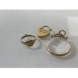 A group of charms including locket, signet style ring and magnifying glass (d.2.5cm), all marked 9k