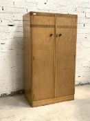 An Art Deco period birds eye maple gentlemans compactum wardrobe, the twin doors enclosing front