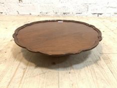 A Victorian mahogany lazy Susan, the scalloped circular tray top over turned pedestal, H11cm, D49cm