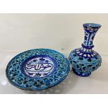 An Iznic dish with pierced edge and Arabic text to well (20cm) and an Iznic vase with pierced