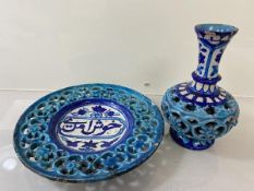 An Iznic dish with pierced edge and Arabic text to well (20cm) and an Iznic vase with pierced