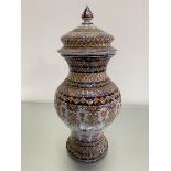 An Italian style faience baluster vase with associated cover, complete with finial, with trailing