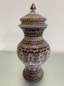 An Italian style faience baluster vase with associated cover, complete with finial, with trailing