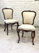 A good pair of Victorian rosewood bedroom chairs in the French taste, the floral carved crest rail