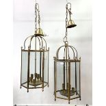 A pair of brass hexagonal hanging lanterns, each with inset glass panels, six branches, chair and