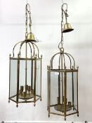 A pair of brass hexagonal hanging lanterns, each with inset glass panels, six branches, chair and