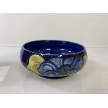 A Moorcroft footed bowl with floral decoration (6cm x 15cm)