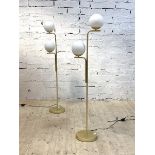 A pair of contemporary gilt brass standard lamps, each with two frosted glass globe shades, H143cm