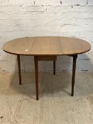 A mid century drop leaf dining table, the oval top raised on turned tapered supports, H73cm, 108cm x