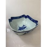 A Chinese blue and white bowl, depicting traditional landscapes, of square scalloped form (13cm x