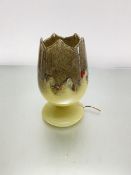 A Monart glass tulip shaped lamp with pyrites, scrolling coloured glass etc., on circular moulded