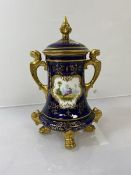 A late 19thc/early 20thc Coalport two handled jar, the lid with finial (tip chipped), with lion