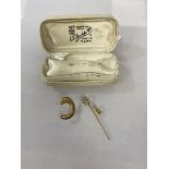 A C shaped earring, post marked 375, post back marked 18k, a yellow metal stick pin with horseshoe