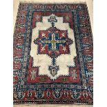 A Turkish hand knotted carpet, the ivory field with geometric medallion and spandrels, within