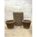 A Large cylindrical lidded wicker basket, containing a quantity of logs (H60cm) together with a pair