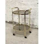 A gilt brass octagonal two tier drinks trolley on castors with lift off tray top H70cm, W50cm,