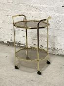 A gilt brass octagonal two tier drinks trolley on castors with lift off tray top H70cm, W50cm,
