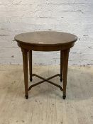 An early 20th century walnut occasional table, the circular top raised on square tapered supports,