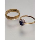 An 18ct gold oval sapphire and diamond cluster ring, approximately thirteen diamonds, mounted in