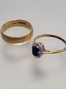An 18ct gold oval sapphire and diamond cluster ring, approximately thirteen diamonds, mounted in