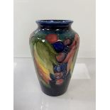 A Moorcroft vase of fruit and leaf design, partial label and signatures to base, potter to M. The