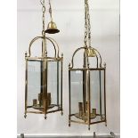 A pair of brass hexagonal hanging lanterns, each with inset glass panels, six branches, chair and