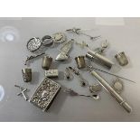 A quantity of silver and white metal charms, jewellery, thimbles, including a Georgian charm in