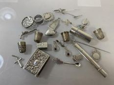 A quantity of silver and white metal charms, jewellery, thimbles, including a Georgian charm in