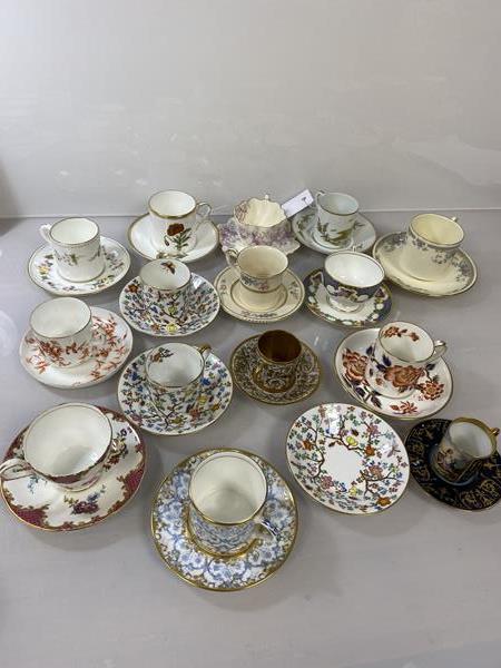 A collection of demi tasse cups and saucers including M.Raynaud, Limoges, made for John Ford &