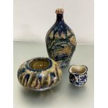 A pottery crush sided bottle style vase decorated with blue, green and red incised floral and bird