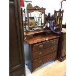 An Edwardian mahogany dressing table the hinged mirror flanked by a pierced and shelf supports
