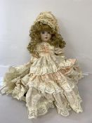 A Scottish china doll in lace dress inscribed Kyla Kraft, Scotland to back of neck, with parasol (