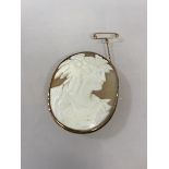 A 9ct gold mounted cameo brooch with safety chain, (5cm x 3.5cm)