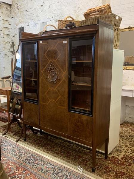 An early 20th century continental inlaid and figured walnut display cabinet, with two glazed doors