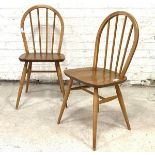 Ercol, a pair of hoop and spindle back chairs, with saddle seats, raised on turned tapered