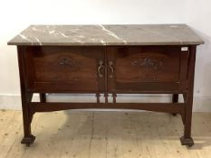 An Art Nouveau period mahogany wash stand, the marble top over twin carved panelled doors, raised on